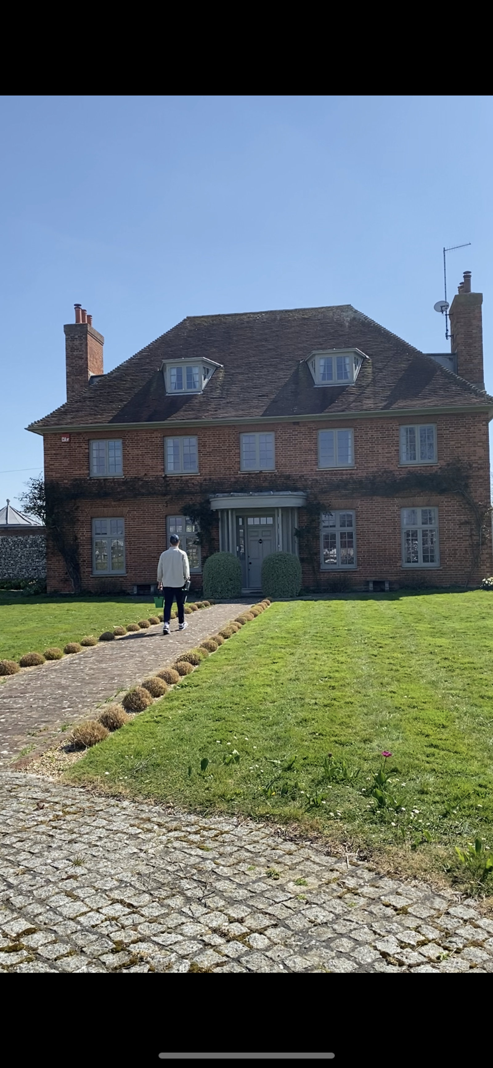 A red-brick country home in West Sussex with freshly cleaned windows