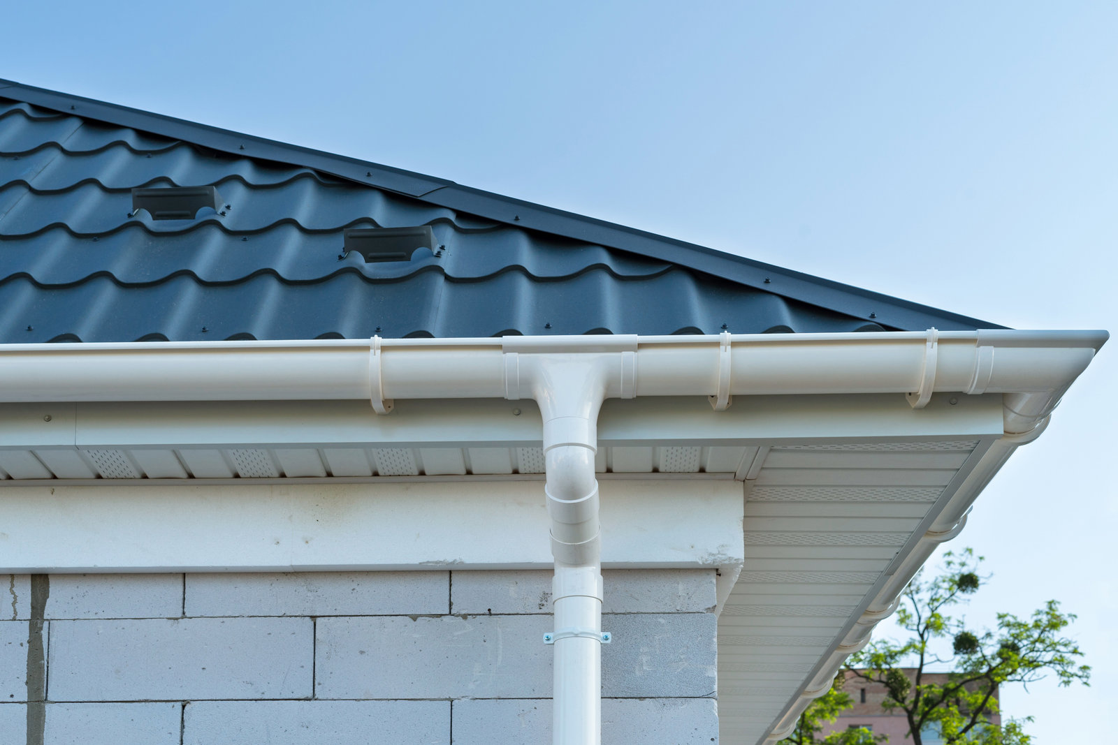 Clean white soffits, fascias and guttering against a tiled roof